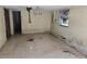 Damaged living room with water stains, missing ceiling tiles, and weathered walls at 613 Chestnut St, Oldsmar, FL 34677
