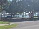 Lakeside scene at R.E. Olds Park showcasing mature trees, parking, and distant water views at 613 Chestnut St, Oldsmar, FL 34677