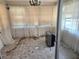 Sunroom with tiled floors, a chandelier, and sheer curtains over windows at 613 Chestnut St, Oldsmar, FL 34677