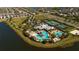 Aerial view showcasing the community pool, clubhouse, tennis courts, and surrounding residential area at 6312 Lantern View Pl, Apollo Beach, FL 33572