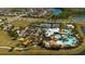 Aerial view of the community amenities, including a pool, clubhouse, tennis courts, and playground at 6312 Lantern View Pl, Apollo Beach, FL 33572