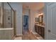 Bright bathroom featuring a glass enclosed shower, double vanity, and wood-look tile floors at 6312 Lantern View Pl, Apollo Beach, FL 33572