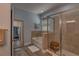 Serene bathroom with soaking tub, glass shower, and wood-look tile at 6312 Lantern View Pl, Apollo Beach, FL 33572