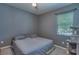 Neutral-toned bedroom featuring gray walls, plush carpeting, and a window with blinds at 6312 Lantern View Pl, Apollo Beach, FL 33572