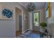 Inviting foyer with hardwood floors, decorative light fixture, and neutral wall colors at 6312 Lantern View Pl, Apollo Beach, FL 33572