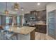 Modern kitchen features granite countertops, stainless steel appliances, and an island with seating, plus adjacent breakfast nook at 6312 Lantern View Pl, Apollo Beach, FL 33572