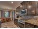 Updated kitchen with granite countertops, stainless steel appliances, and a nearby breakfast nook for casual dining at 6312 Lantern View Pl, Apollo Beach, FL 33572