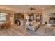 Open living space with hardwood floors, kitchen island, dining area, and comfortable seating at 6312 Lantern View Pl, Apollo Beach, FL 33572