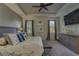 Spacious main bedroom showcasing a tray ceiling, a wood-look accent wall, and large windows, plus carpeted floors at 6312 Lantern View Pl, Apollo Beach, FL 33572
