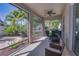 Screened patio showcasing an outdoor living space with comfortable seating, lush landscaping, and a ceiling fan at 6312 Lantern View Pl, Apollo Beach, FL 33572