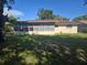 Home's backyard and sunroom with many windows at 704 Lemonwood Dr, Oldsmar, FL 34677