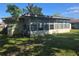 Home's sunroom as seen from the backyard at 704 Lemonwood Dr, Oldsmar, FL 34677