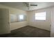 Simple bedroom with a window, mirror, ceiling fan, and closet at 704 Lemonwood Dr, Oldsmar, FL 34677