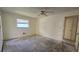 Empty bedroom with ceiling fan and window, ready for customization at 704 Lemonwood Dr, Oldsmar, FL 34677