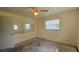 Bedroom featuring a ceiling fan, large mirror and one window at 704 Lemonwood Dr, Oldsmar, FL 34677