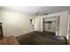 Bedroom features a ceiling fan, closet, and view to a bathroom at 704 Lemonwood Dr, Oldsmar, FL 34677