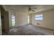 Spacious bedroom with a ceiling fan, and ample natural light at 704 Lemonwood Dr, Oldsmar, FL 34677