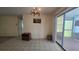 Dining area featuring tile flooring, chandelier and sliding glass door access at 704 Lemonwood Dr, Oldsmar, FL 34677