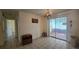 Dining area with tile floors, chandelier, and sliding glass door at 704 Lemonwood Dr, Oldsmar, FL 34677