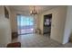 Bright dining room with tiled flooring and sliding glass door to the enclosed patio at 704 Lemonwood Dr, Oldsmar, FL 34677