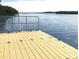 Dock features durable composite wood with a serene waterfront view, perfect for enjoying peaceful moments by the water at 704 Lemonwood Dr, Oldsmar, FL 34677