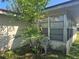 Side of house with adjacent chair and tree at 704 Lemonwood Dr, Oldsmar, FL 34677