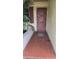 Front entrance featuring a solid front door and tiled walkway at 704 Lemonwood Dr, Oldsmar, FL 34677