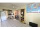 The kitchen area with room for storage, shelving, a world map and TV at 704 Lemonwood Dr, Oldsmar, FL 34677