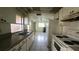 A view of the kitchen featuring tile floors, older appliances, and lots of storage at 704 Lemonwood Dr, Oldsmar, FL 34677