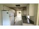 A kitchen with white appliances, and tile flooring at 704 Lemonwood Dr, Oldsmar, FL 34677