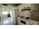 Kitchen with white appliances, tile flooring, and white cabinetry at 704 Lemonwood Dr, Oldsmar, FL 34677