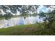 Scenic lake view with lush greenery and trees surrounding the tranquil water at 704 Lemonwood Dr, Oldsmar, FL 34677