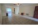 Open living space with tiled floors leading to a sliding glass door at 704 Lemonwood Dr, Oldsmar, FL 34677