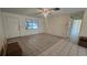 Spacious living room featuring tile flooring, a window, and a ceiling fan at 704 Lemonwood Dr, Oldsmar, FL 34677