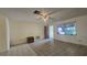 Bright living room with neutral walls, tiled floor, and a ceiling fan at 704 Lemonwood Dr, Oldsmar, FL 34677