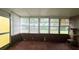 Enclosed patio featuring multiple windows for natural light and tiled flooring at 704 Lemonwood Dr, Oldsmar, FL 34677