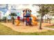 Community playground with slides, swings, climbing wall and tower offer fun activities for children, set in mulch at 704 Lemonwood Dr, Oldsmar, FL 34677