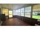A sunroom featuring multiple windows and tile floors, providing a bright and airy space at 704 Lemonwood Dr, Oldsmar, FL 34677