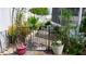 Enclosed backyard with rock covering, featuring a metal gate and plant life at 7321 San Moritz Dr, Port Richey, FL 34668
