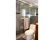 Bathroom featuring glass shower door, gray tiled walls, and modern fixtures at 7321 San Moritz Dr, Port Richey, FL 34668