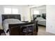 Bedroom featuring a dark wood sleigh bed, bedside tables with lamps, and a mirrored closet at 7321 San Moritz Dr, Port Richey, FL 34668