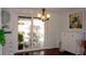 Well-lit dining room with sliding glass doors to backyard and stylish decor and furnishings at 7321 San Moritz Dr, Port Richey, FL 34668