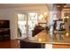 Open kitchen with breakfast bar, granite countertops, and backyard views at 7321 San Moritz Dr, Port Richey, FL 34668