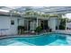 Screened pool with covered access and outdoor seating at 7321 San Moritz Dr, Port Richey, FL 34668