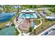 Stunning aerial view of community amenities, pool, clubhouse, playground and sport court with a lake at 7336 Bagley Cove Ct, Sun City Center, FL 33573