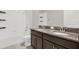 Bathroom featuring dual sinks, vanity, and shower, offering a convenient and luxurious experience at 7336 Bagley Cove Ct, Sun City Center, FL 33573