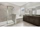 Well-lit bathroom featuring a tiled shower, soaking tub, and double vanity with granite countertop at 7336 Bagley Cove Ct, Sun City Center, FL 33573