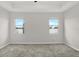 Bright bedroom with ample natural light, neutral carpet, and a view of the serene outdoor landscape at 7336 Bagley Cove Ct, Sun City Center, FL 33573
