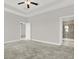 Comfortable bedroom with soft carpet, a ceiling fan, and access to an en-suite bathroom and closet at 7336 Bagley Cove Ct, Sun City Center, FL 33573