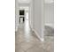Inviting hallway with light gray walls, tile floors, and views into the open-concept living spaces at 7336 Bagley Cove Ct, Sun City Center, FL 33573